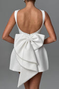 Lillian | Stylish slim-fit mini dress with a large bow and beaded detailing