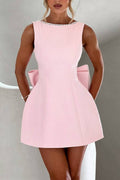Lillian | Stylish slim-fit mini dress with a large bow and beaded detailing