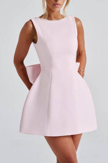 Lillian | Stylish slim-fit mini dress with a large bow and beaded detailing