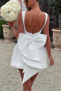 Lillian | Stylish slim-fit mini dress with a large bow and beaded detailing