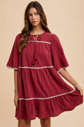 Aaliyah® | Tiered dress with tassels and contrast trim, tied neckline, half sleeves