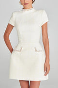 Leslie® | Exquisite and playful mini dress made of tweed fabric with beaded trim, short sleeves and pockets